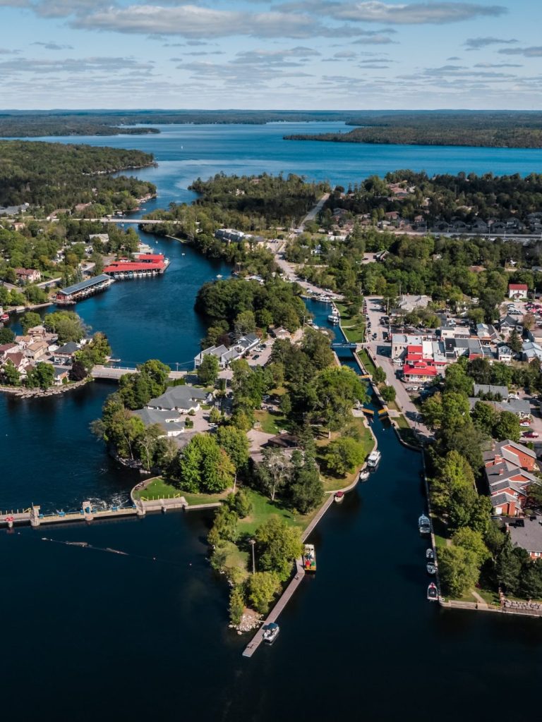 Aerial view of town on a lake, with several areas connected by bridge