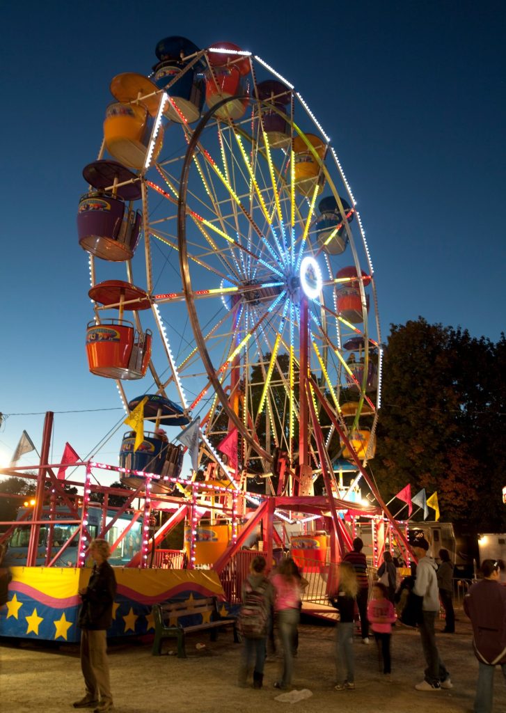 A colourful Ferris wheel at night