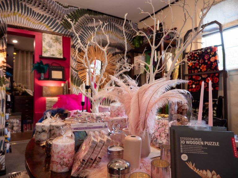 Detailed,delicate arrangement of flowers, branches, and giftware in a home decor store