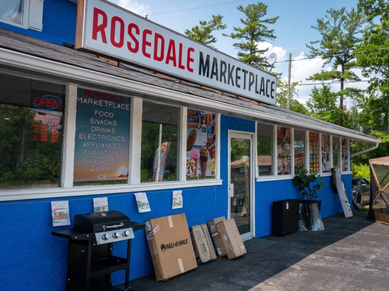 Exterior of blue building with sign reading "Rosedale Marketplace"