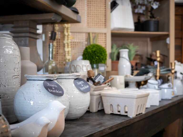 A selection of giftware such as teapots and vases, with labels reading Barn and Bunkie